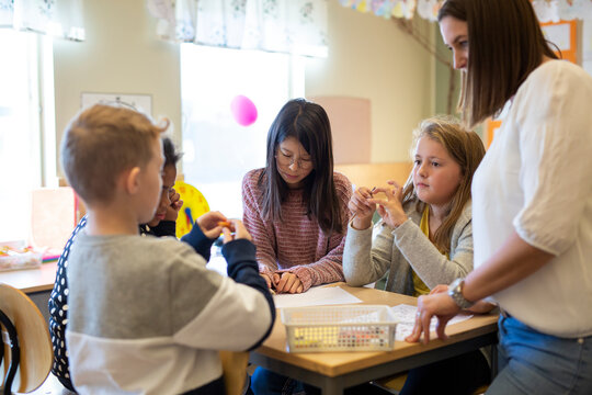 Teacher with children in classroom, Sweden