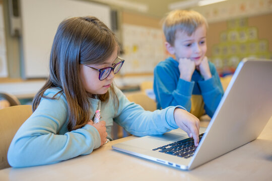 Girl using laptop in classroom, Sweden