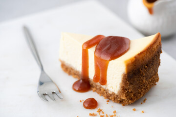 Cheesecake with caramel sauce, closeup view, selective focus