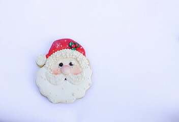 santa claus decorated cookie on a white background