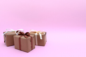 Wrapped presents with ribbons on pink background. Gift concept