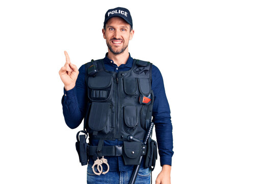 Young handsome man wearing police uniform with a big smile on face, pointing with hand finger to the side looking at the camera.