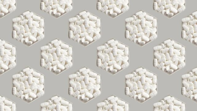Medical capsules alternating from left to right on gray background