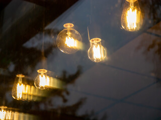 garland of yellow incandescent lamps hanging through the glass
