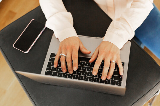Hands typing on laptop keyboard, Sweden