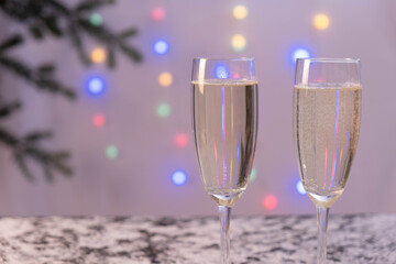 colored garlands full of champagne glasses stand on the table