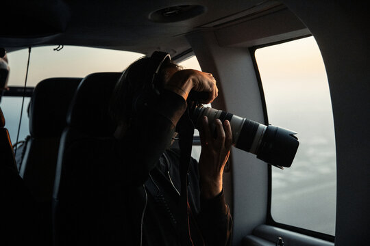 Photographer taking photos from plane, United Kingdom