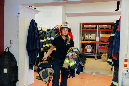 Female firefighter in fire station, Sweden