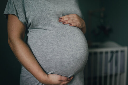 Pregnant woman with hands on belly, Sweden