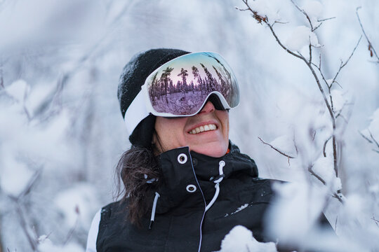 Smiling woman wearing ski goggles, Sweden