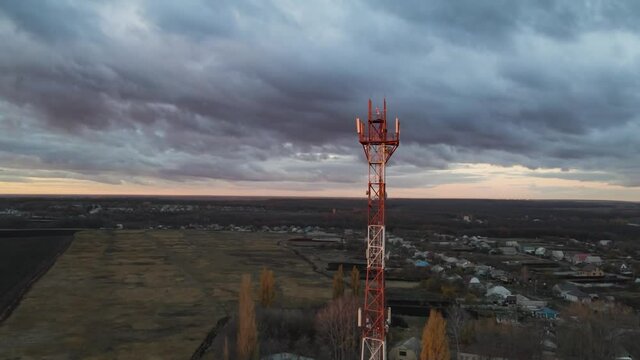 Telecommunication tower of 4G and 5G cellular or Base Transceiver Station in countryside village. Wireless Communication Antenna Transmitter. Aerial view footage