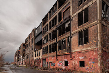 Fototapeta na wymiar Detroit abandoned broken dystopian factory warehouse crumbling into nightmare apocalypse - Tilt Shift - winter landscape