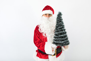 Santa Claus holding a Christmas tree on white background. Christmas concept