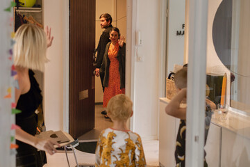 Woman waving while leaving apartment, Sweden