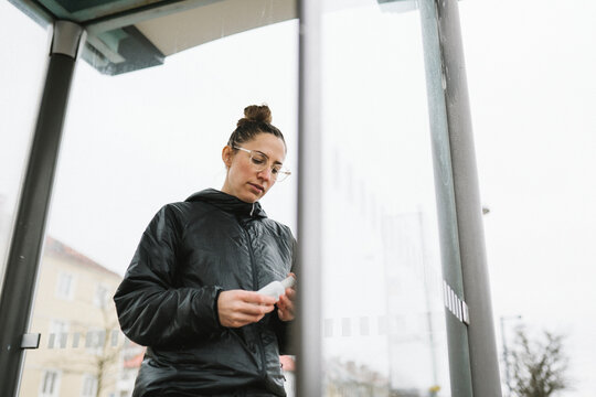 Woman applying antibacterial gel on her hands, Sweden