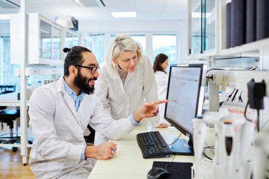 Scientists analyzing chart on computer screen, Sweden