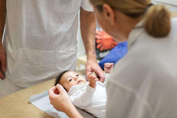 Female doctor examining baby, Sweden