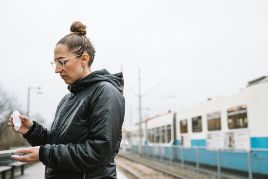 Woman applying antibacterial gel on her hands, Sweden
