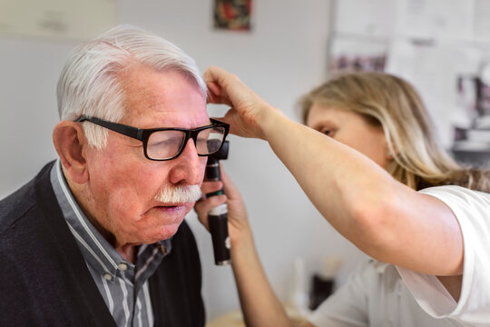 Doctor checking patient's ear, Sweden