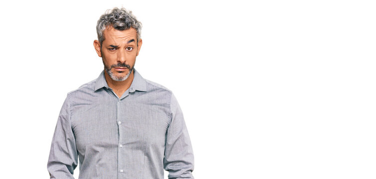 Middle age grey-haired man wearing casual clothes skeptic and nervous, frowning upset because of problem. negative person.