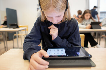 Girl in classroom using digital tablet, Sweden