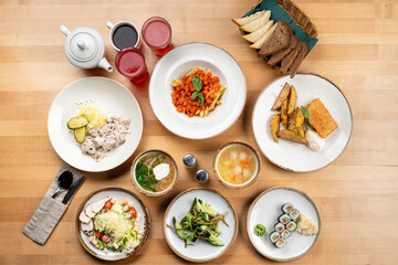 Top view of variety of meals of a european restaurant, soft light, directly above