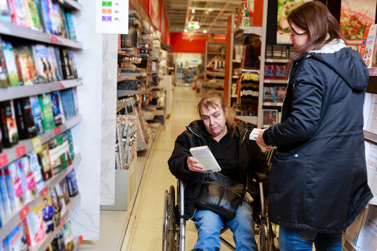 Female carer helping woman with shopping, Sweden