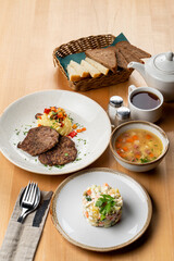 Whole branch on light wooden table, menu photography of different european meals