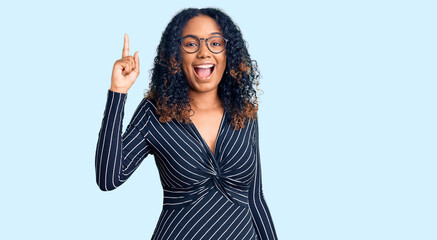 Young african american woman wearing casual clothes and glasses pointing finger up with successful idea. exited and happy. number one.