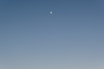 
Sunset on the beach with half moon and sand