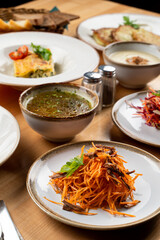 Carrot salad with forest mushrooms and grated carrot, meals and plated in background