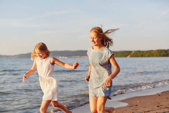 Girls running on beach, Sweden