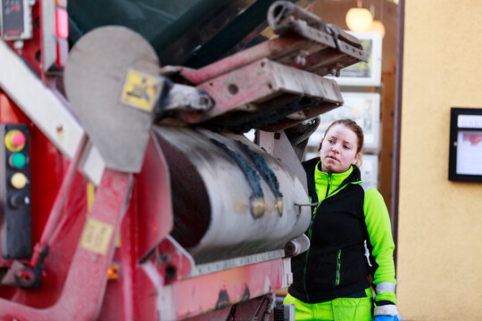 Woman operating garbage truck, Sweden