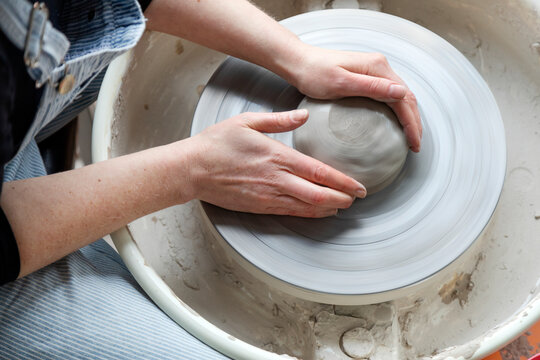 Womans hands modeling clay, Sweden
