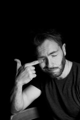 A man on a dark background.Thirds of the eyes from fatigue or insomnia.