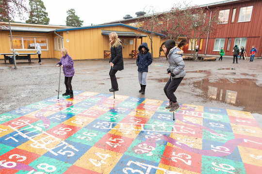 Girls jumping on pogo sticks, Sweden
