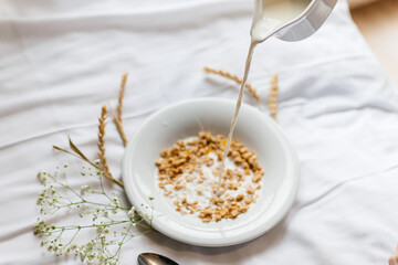 plate with breakfast on a white bed with flowers