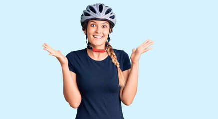 Beautiful caucasian woman wearing bike helmet celebrating crazy and amazed for success with arms raised and open eyes screaming excited. winner concept