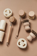 Kitchen Dish Brushes on Isolated Beige Background Side View Copy Space. Little Mug Made from Ecology Clean Nature Material Clay with Eco Clean Bath Accessory