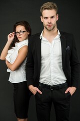 Young and successful. Professional couple dark background. Businessman and businesswoman in formal wear. Professional occupation and career. Business activities