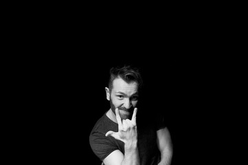 A man on a dark background. A cheeky pose. You deserve it.