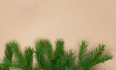 Traditional green christmas tree noble fir border frame on craft paper background with copy space.