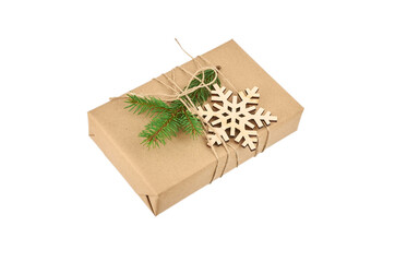 Christmas gift box decorated with fir tree branch and wooden snowflake isolated on white background