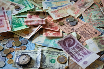 Old banknotes and coins of different countries close-up.