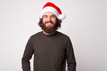 Portrait of smiling man looking confident at the camera and wearing Santa Claus cap