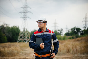 An energy worker inspects power lines. Energy