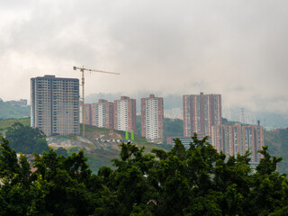 Fototapeta premium Aerial View of Many Condominiums, High-Rise Buildings in the Mountains