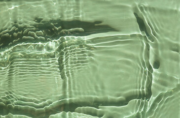 Surface texture with splashes and bubbles. Abstract nature background. Cosmetic moisturizer water green.