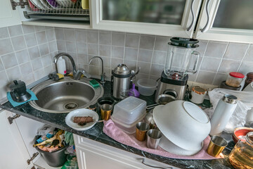 Fototapeta na wymiar Kitchen mess. Kitchenware, pile of dirty untidy utensils in sink washbasin