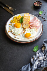 English breakfast fried egg, bread toast, vegetables, corn, cheese and more ready to eat on the table serving healthy meal snack ingredient top view copy space for text food background rustic